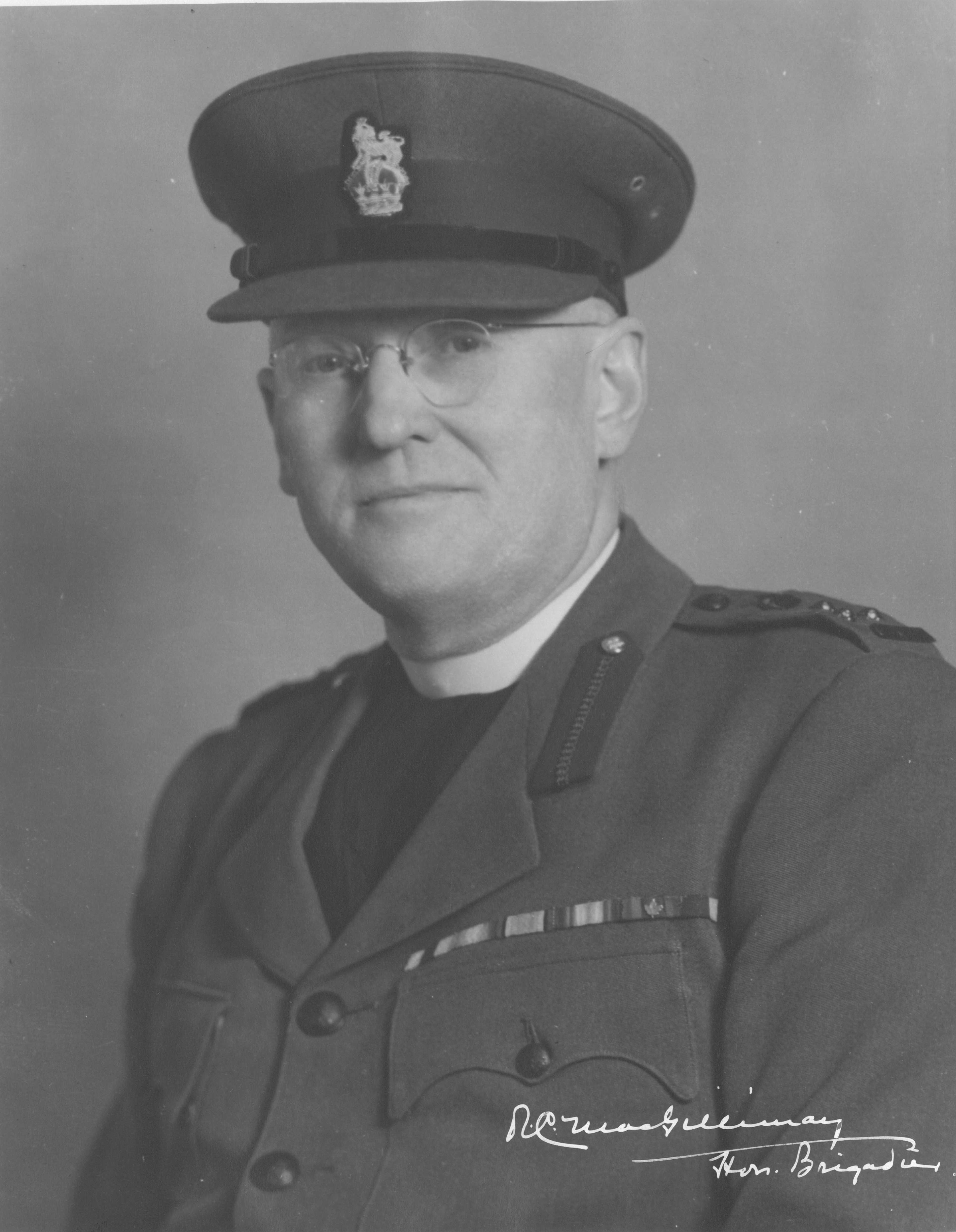 Black and white portrait. MacGillivray is shown from the chest up, service decoration bars visible on his jacket. He is wearing a military uniform and hat.